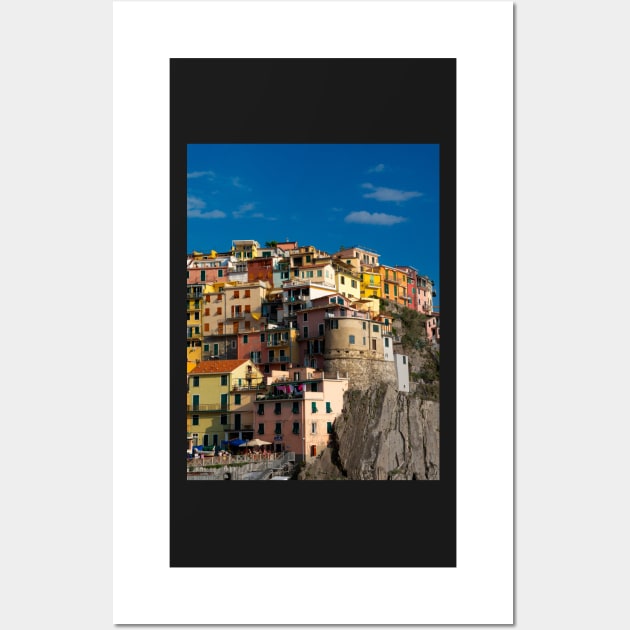 View on the cliff town of Manarola, one of the colorful Cinque Terre on the Italian west coast Wall Art by Dolfilms